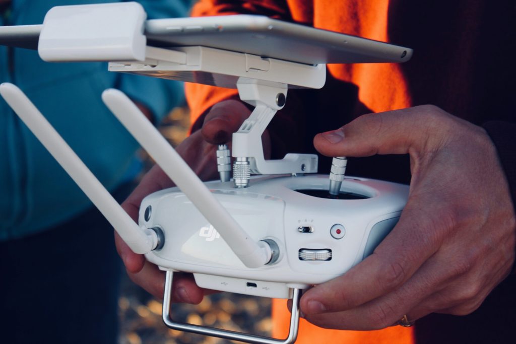 Hands hold a drone remote controller
