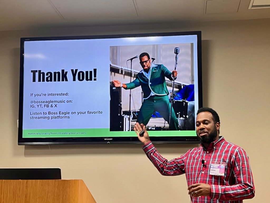 A presenter in a plaid shirt points to a Thank You slide during his Founded in FoCo session